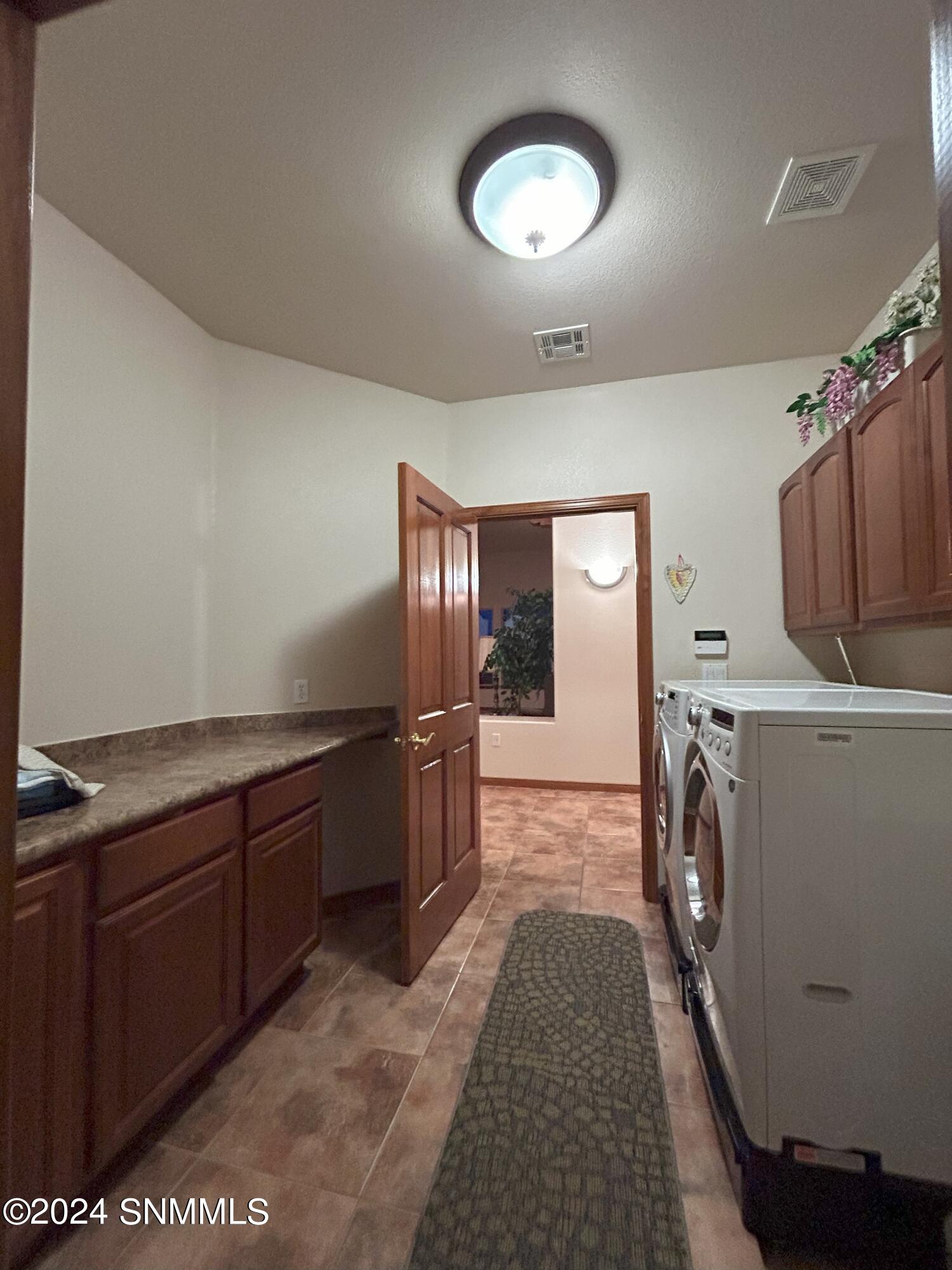 16. Laundry Room with cabinets and Foldi