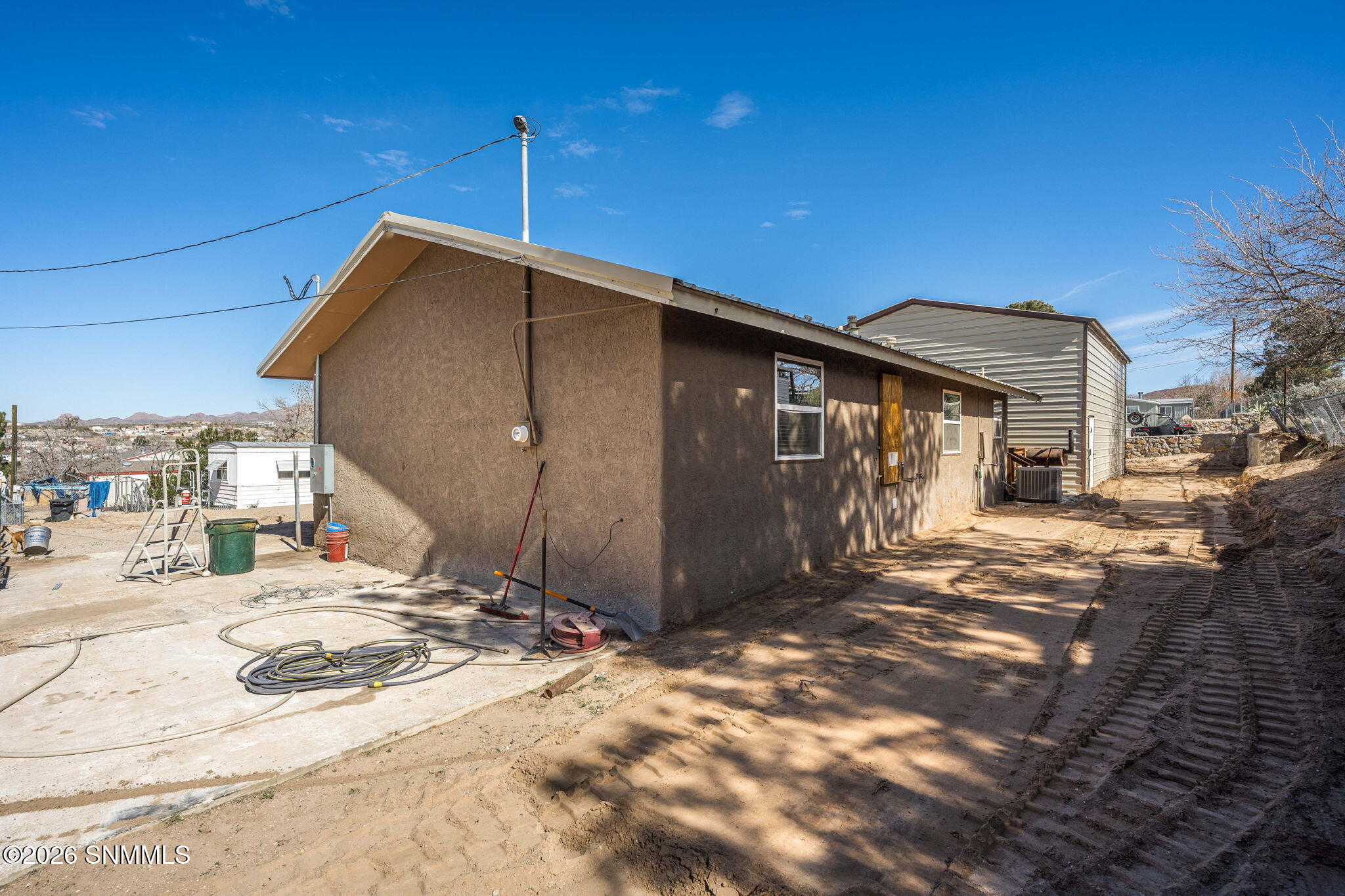 Backside of house with concrete pad